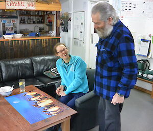 Louise and Lionel in the mess looking at a penguin puzzle