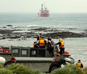 LARC with crew aboard on the beach and ship in background