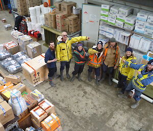 Group of expeditioners in the store with many packages