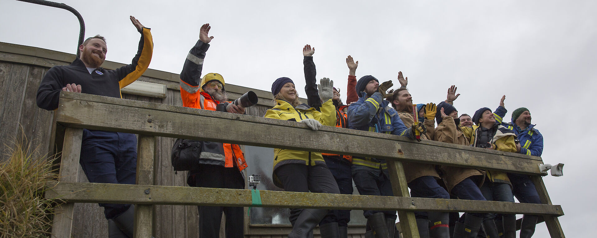 Expeditioners at Hamshack balcony waving