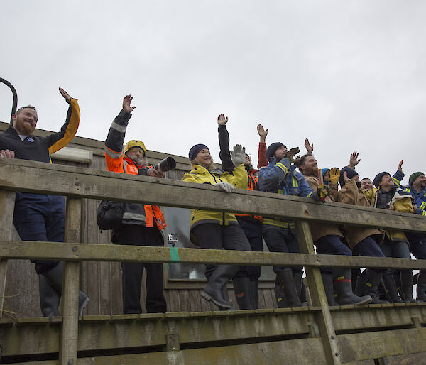 Expeditioners at Hamshack balcony waving