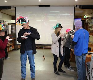 Expeditioners in front of big screen showing horse race