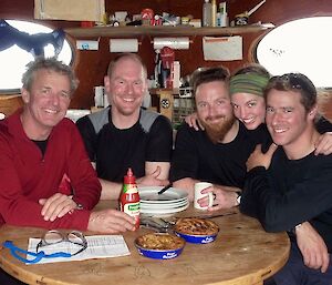 Terry, Rich, Jimmy, Helena and Robbie at Brother’s Point Hut. Sitting at table with Fray Bentos canned pie in foreground.