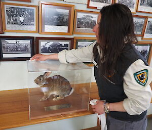 Andrea holding the glass case with the rabbit