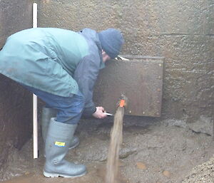 Ben opening a valve at the dam