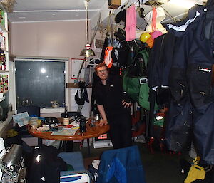 Chris negotiating a jungle of drying gear in the Hurd Point hut after a particularly wet day on the slopes