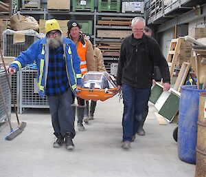 Expeditioners walking with the stretcher