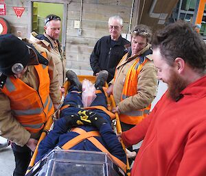 Expeditioners holding a stretcher