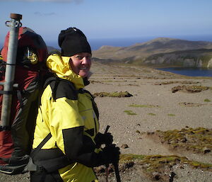 Kate in yellow jacket with plateau in rear background