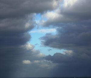 Blue sky peeks through the clouds