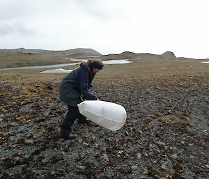 Expeditioner using a sweep net to collect invertebrates