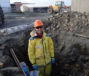 Jeremy Rstanding in a pit in yellow waterproofs