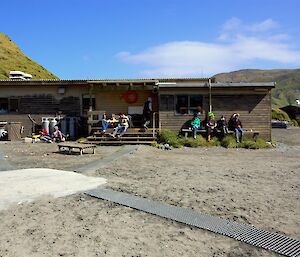 Expeditioners sitting outside the Mess in sun
