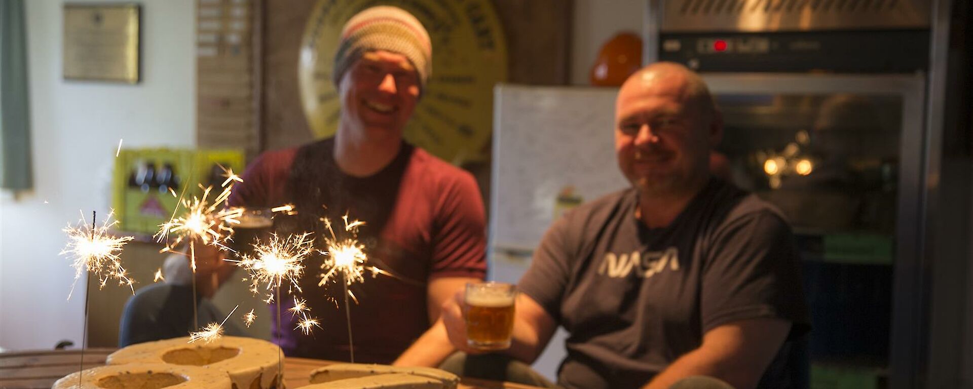 Rich (and Rob with their birthday cake with sparklers