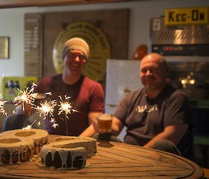 Rich (and Rob with their birthday cake with sparklers