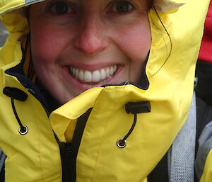 Jane smiling in rain gear with hood up