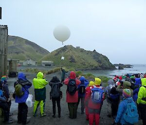 Tourists watching a weather balloon release