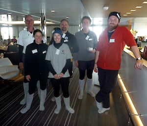 Expeditioners in socks and thermals in a ship’s mess