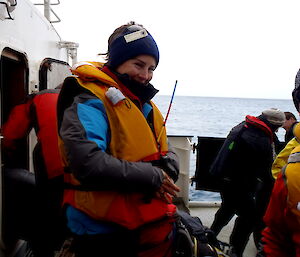 Rowena in a lifejacket on a ship deck