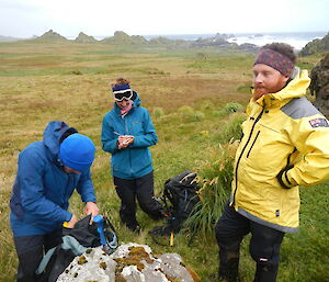 Three expeditioners on the plateau conducting a survey