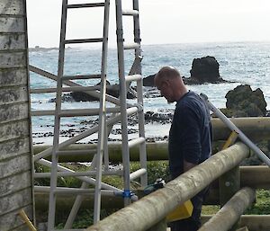 Nick standing beside building with scaffolding