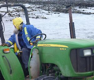 Lionel reversing a tractor to launch an inflatable rubber boat into the water