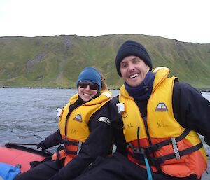Rowena and Tim in small rubber boat smile for cameras