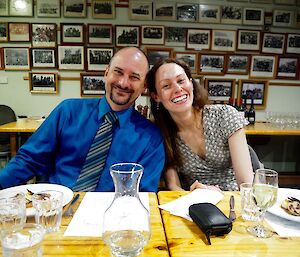 A male and female expeditioner in nice dinner clothes smile for the camera