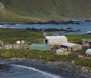 Shot of station and various activities with fuel line in foreground.