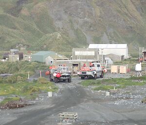 Two LARCS, land and water boats, meet on the isthmus road outside the Comms building