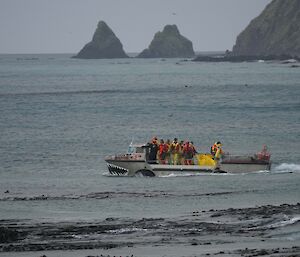 Two LARC boats with wheels in the water. The rocks of the Nuggets in the background.