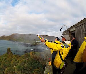 Marcus & Helen letting off flares on the Ham shack balcony. Vista of south of the island in background.