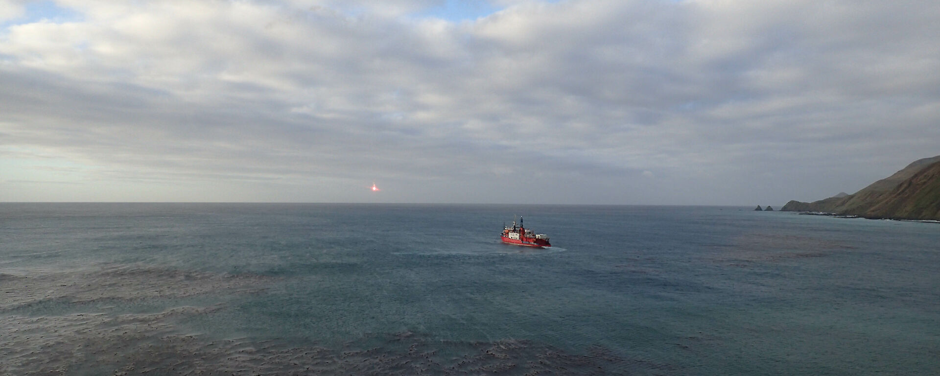 L'Astrolabe heading off for the horizon with flares sparks in shot