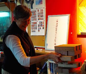 Dr Helen removing a block during the game of giant Jenga