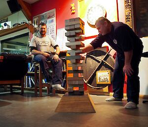 Rob having a turn as the giant Jenga tower has more gaps and becomes more precarious. Ben in background watching on.