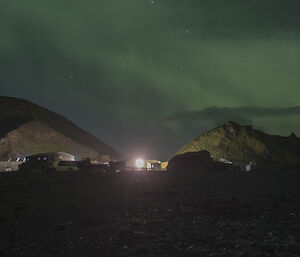 Landscape of station buildings with aurora in the sky above