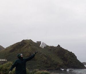 A man is letting go of a large ballon