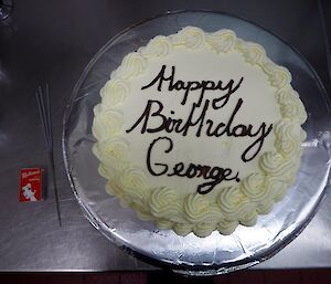 A birthday cake with Happy Birthday George written on it.
