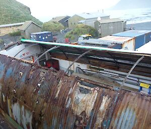 Top view of the shed with one side finished and the other side still a rusty mess.