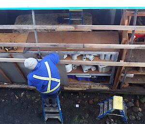 Top shot of a man working on the exposed side of the building