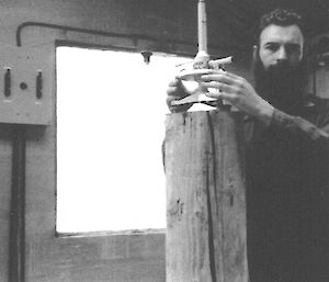 A B&W photo from Colin Robertson’s diary of him using a magnetometer on Macquarie Island in 1954