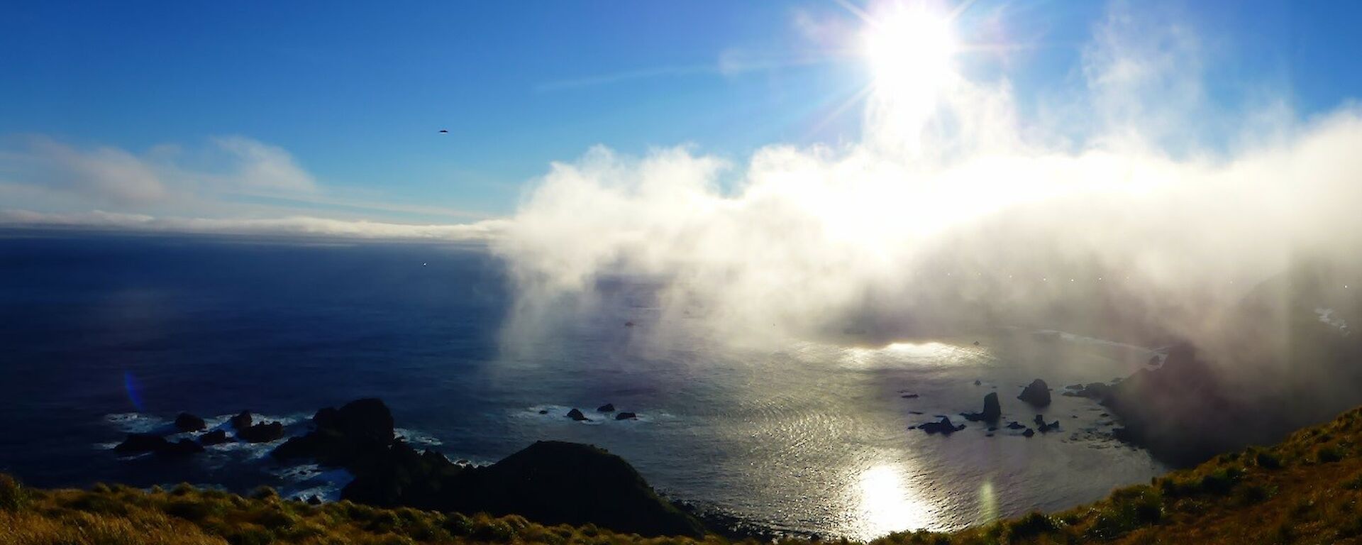 Blue sky over the coastline at the southern end of the island