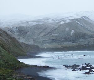 A view of Sandy Bay at mid tide with snow on the hills