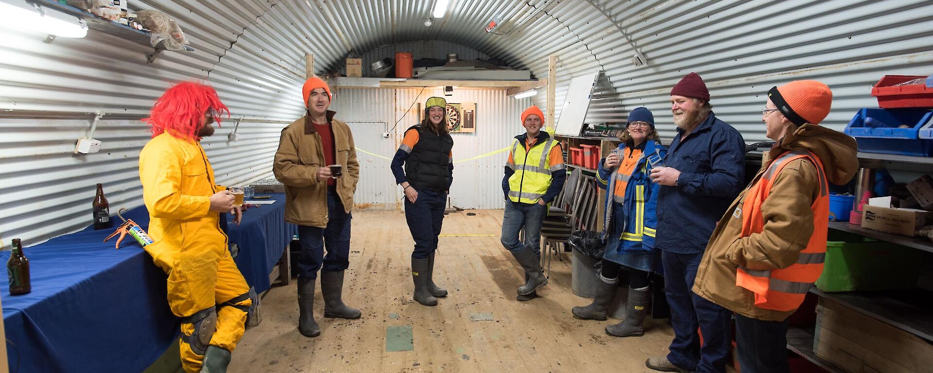 People are gathered inside a Nissen hut