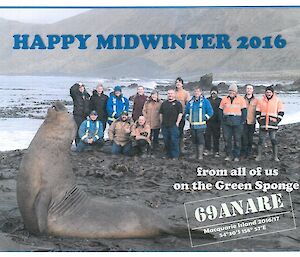A group photo of the macquarie Island winterers with an elephant seal in foreground