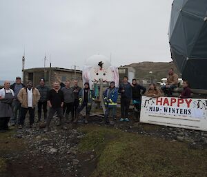 A group photo with Happy Midwinter sign.