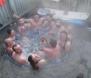 A group of people crammed into a steamy spa