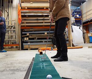 A woman putting on the final green.