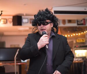 A man dressed as Roy Orbison performs