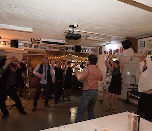 A group of people dancing to the YMCA